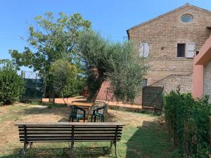 a park bench sitting in front of a building at Lu Prete in Campofilone
