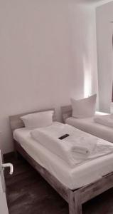 a bed in a room with a white bedspread at Hotel Sickinger Hof in Berlin