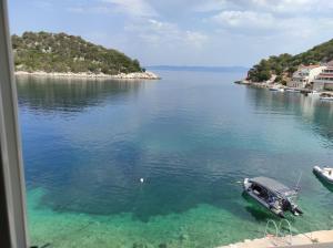 a boat is docked in a large body of water at Apartmani Kate in Lastovo