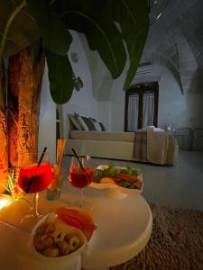 a table with a plate of food and drinks on it at Suite il Vicoletto in Crispiano +17 photos