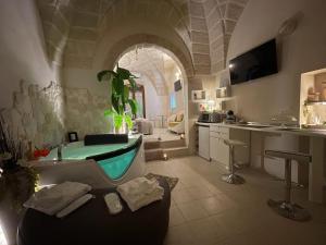 a bathroom with a tub and a sink and a kitchen at Suite il Vicoletto in Crispiano