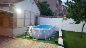 a swimming pool in the backyard of a house at Casa del maestro in Orbita