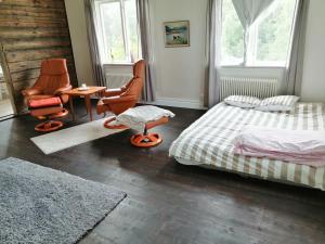 a bedroom with two beds and a table and chairs at My river house (basic) in Föllinge