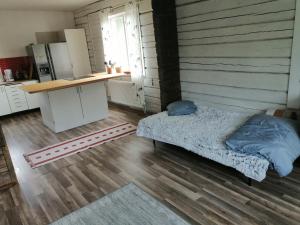 a bedroom with a bed and a desk in it at My river house (basic) in Föllinge