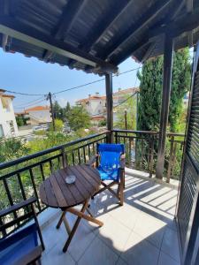 a patio with a table and a chair on a balcony at Tassos 2 in Pefkochori