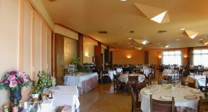 a banquet hall with white tables and chairs at Hotel Rey Sancho Ramírez in Barbastro +19 photos