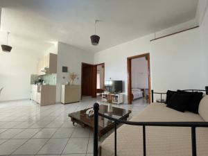 a living room with a couch and a kitchen at Nostalgia Villas in Tersanas