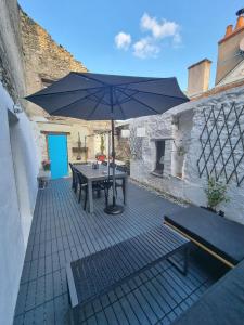 a picnic table with an umbrella on a patio at Maison avec terrasse au coeur de Sancerre in Sancerre