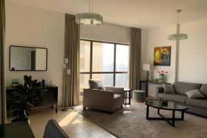 a living room with a couch and a table at Beautiful apartment with amazing sea views in Dubai