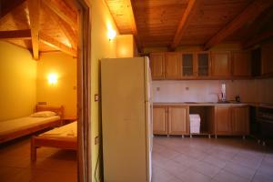 a kitchen with a white refrigerator in a room at Pension Maria in Lefkada