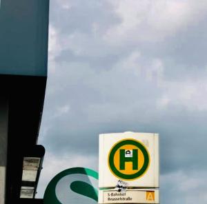 a gas station sign in front of a cloudy sky at Hotel Sickinger Hof in Berlin