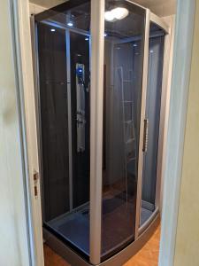 a glass shower stall in a room with at Le Petit Moulin in Fouday
