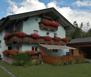 a house with flower boxes on the side of it at Sand 4 in Stanzach