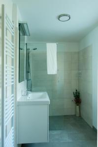 a white bathroom with a sink and a mirror at Ferienwohnung Stefanie in Bad Mitterndorf