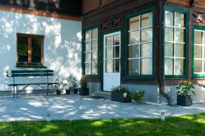 a porch of a building with a bench and windows at Ferienwohnung Stefanie in Bad Mitterndorf