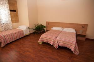 Letto o letti in una camera di Albergo Conca D'Oro