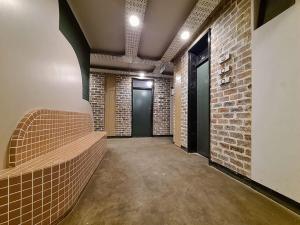 a hallway with a brick wall and a door at Maboneng City Building Free WiFi and Swimming pool in Johannesburg