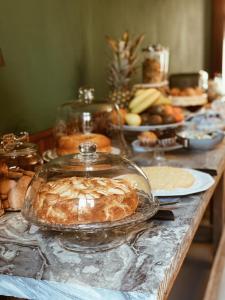 a table with a display of bread and other foods at Art Hotel Pietrasanta in Pietrasanta