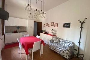 a living room with a table and a couch at 6.4.6 - Via Jodi 6 in Reggio Emilia