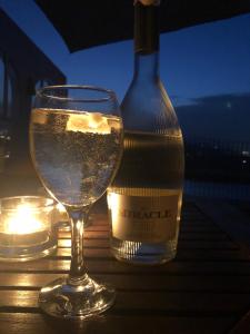 a glass of water next to a bottle of wine at Villa Luz del Monte in Denia