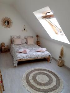 a bedroom with a bed with a rug on the floor at Côte d Opale - Chambre cocooning in Rinxent