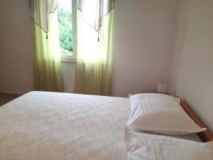 Postel nebo postele na pokoji v ubytování Apartments Niksa