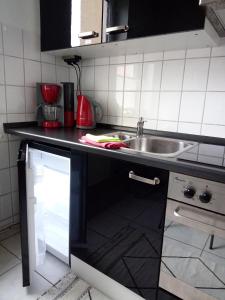 a kitchen with a sink and a counter top at SUNNY SIDE in Kiel