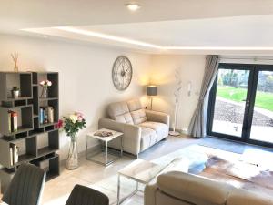 a living room with a couch and a table at Millstream Mews in Bakewell