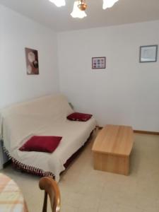 a bedroom with a bed and a wooden table at Gîte en Brenne Les Chênes in Mérigny