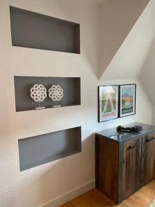 a wall with two shelves and a counter in a room at Zielone walizki in Polanica-Zdrój +36 photos