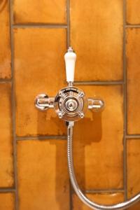 a shower with a hose attached to a wall at The Turks Head in Exeter +44 photos