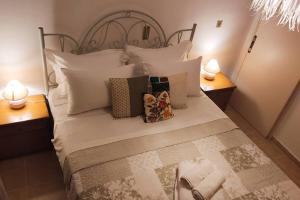 a bedroom with a bed with pillows and two lamps at Apartment 95 m2, center of Sitia, WiFi, 350m beach in Sitia