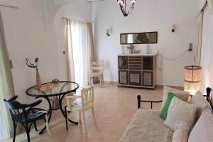 a living room with a table and a couch at Apartment 95 m2, center of Sitia, WiFi, 350m beach in Sitia