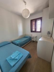 A bed or beds in a room at Villetta Torre Saracena