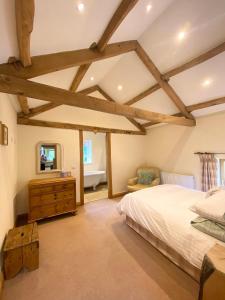 a bedroom with a bed and a dresser and a mirror at The Barn in Bedale