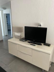 a white entertainment center with a television on top of it at 61 BIS ST GEORGES DE DIDONNE in Saint-Georges-de-Didonne