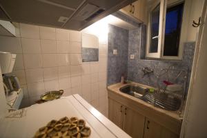 a small kitchen with a sink and a counter top at Belivanovi B&B House in Veliko Tŭrnovo +17 photos