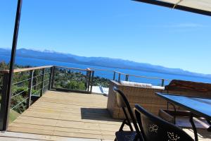 a balcony with a view of the water at Ventanas Al Lago in San Carlos de Bariloche