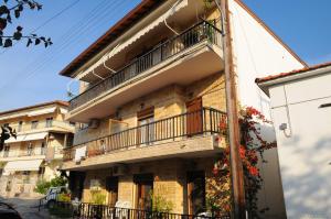 a building with a balcony on the side of it at Giota Studios in Ammouliani
