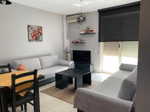 a living room with a couch and a table at FRESKIA GOLEM in Golem