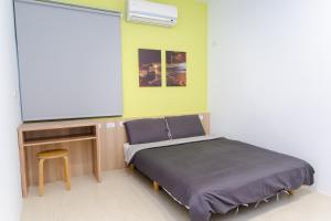 Llit o llits en una habitació de Colorful B&B