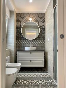 a bathroom with a sink and a mirror at Le Calette House - Puglia Mia Apartments in Monopoli