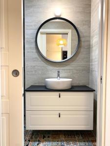 a bathroom with a sink and a mirror at Le Calette House - Puglia Mia Apartments in Monopoli