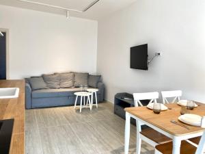 a living room with a couch and a table at Le Calette House - Puglia Mia Apartments in Monopoli