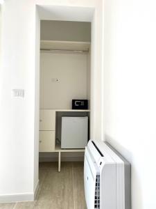a white room with a tv and a refrigerator at Le Calette House - Puglia Mia Apartments in Monopoli
