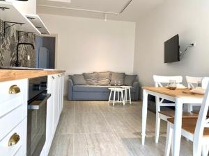 a living room with a couch and a table at Le Calette House - Puglia Mia Apartments in Monopoli