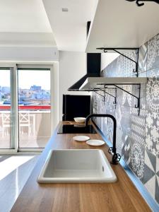 a kitchen with a sink and a counter top at Le Calette House - Puglia Mia Apartments in Monopoli