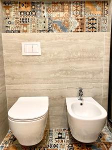 a bathroom with a toilet and a sink at Le Calette House - Puglia Mia Apartments in Monopoli