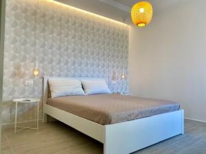 a bedroom with a large bed in a room at Le Calette House - Puglia Mia Apartments in Monopoli