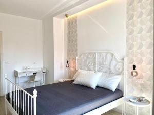 a bedroom with a large bed with a white headboard at Le Calette House - Puglia Mia Apartments in Monopoli